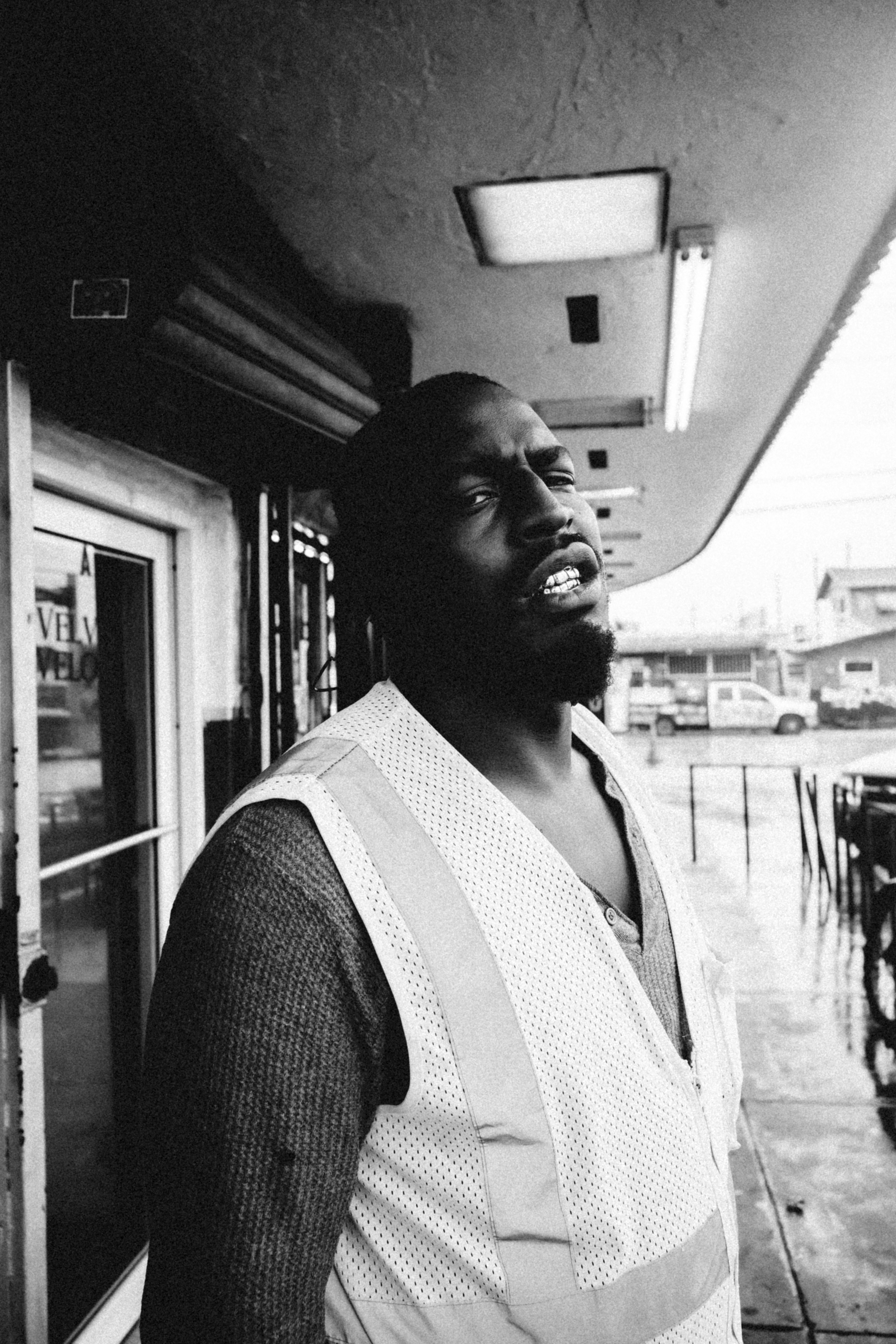 grayscale photo of man in black and white shirt